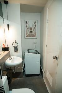 a bathroom with a white toilet and a sink at 2-Bedroom Elegant Condo - Butuan Retreat in Butuan