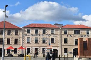a large brick building with a sign on it at Lizzy's Hideaway, Close to City in West Hobart