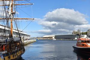 two boats are docked at a dock in the water at Lizzy's Hideaway, Close to City in West Hobart