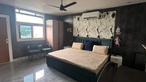 a bedroom with a bed with a blue head board at Sky homestay in Dehradun