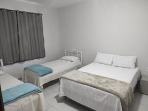 Ένα ή περισσότερα κρεβάτια σε δωμάτιο στο Casa Recanto Feliz, espaço inteiro em Uberlândia próximo ao Umuarama e Aeroporto