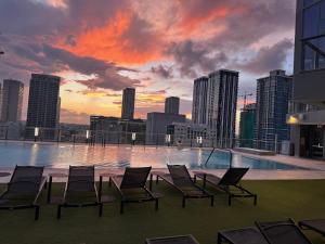 a group of chairs sitting on the roof of a building at The Downtown Luxury Collection in Miami