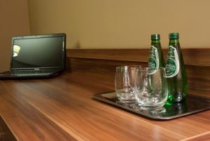 a glass of beer sitting on top of a wooden table at Hotel Dwór Galicja in Stalowa Wola