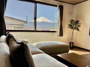 a living room with a view of a mountain through a window at HAOSTAY Villa Oishi Park in Fujikawaguchiko