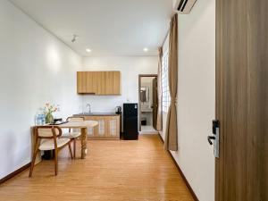 a kitchen with a table and a dining room at The Cozy Nest in Ho Chi Minh City +48 photos