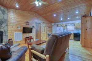 a living room with a couch and a television in a cabin at Into the Wild in Cosby