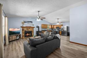 a living room with a couch and a fireplace at Red Rock Ranch in Cosby