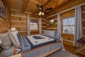 a bedroom with a bed in a log cabin at Hidden Hideaway in Cosby