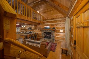 a living room with a fireplace in a log cabin at Hidden Hideaway in Cosby