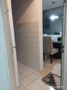 a bathroom with a shower with a table and a chair at Mi casa su casa 3 in Londrina +11 photos