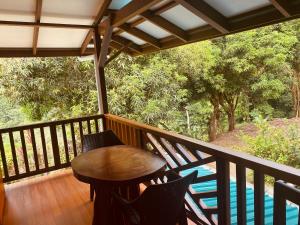 a balcony with a table and chairs and a pool at Vida Buena in Drake +20 photos