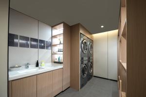 a laundry room with a sink and a washing machine at Atour Hotel Shanghai Dapu Bridge ASE Center in Shanghai +27 photos