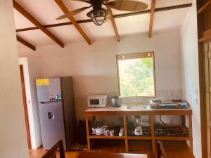 a kitchen with a sink and a window next to a refrigerator at Vida Buena in Drake