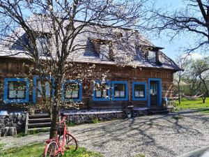 a red bike parked in front of a house at Breb s Cosy Barn in Breb