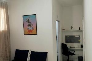 a living room with a picture on the wall at Casa Florescer in Salvador