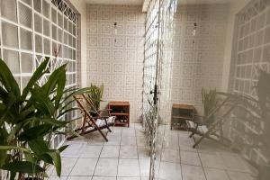a living room with two chairs and a fireplace at Casa Florescer in Salvador