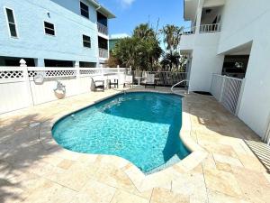 a swimming pool in front of a building at Hidden Pearl home in Holmes Beach