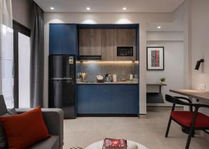a kitchen with a black refrigerator and a table at Exclusive stay with luxury touches at 22 by spacey #55 Studio in Maadi in Cairo