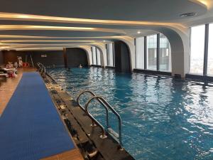 a large swimming pool in a building with water at 2 Bedroom Luxury Apartment Diamond Crown Hai Phong in Ðông Khê +12 photos