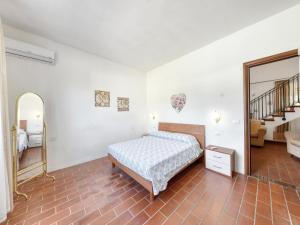 a bedroom with a bed and a mirror at Villa with private pool in Floridia +55 photos