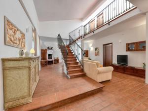 a living room with a staircase and a couch at Villa with private pool in Floridia