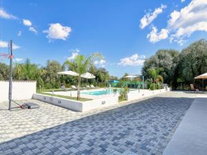 a resort with a swimming pool and umbrellas at Villa with private pool in Floridia