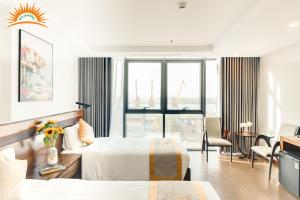 a hotel room with two beds and a living room at Khách sạn Solis Hotel in Hai Phong +60 photos
