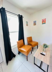 a room with two chairs and a table and a window at Spacious Studio 10 mins to Mia&Downtown in Miami