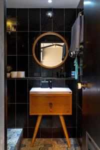 a bathroom with a sink and a mirror at Thip Residence at Surawong in Bang Rak +59 photos
