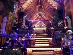 a group of people sitting in a building with stairs at Thip Residence at Surawong in Bang Rak