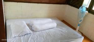 a room with a bed with two towels on it at batu putih cottage karimunjawa in Karimunjawa