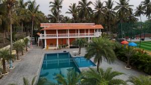 an aerial view of a resort with a swimming pool at Metro Club Resort in Kāmānayakkanpālaiyam