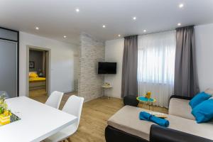 a living room with a couch and a table at Apartments And Studio Giovanni 1 in Trogir
