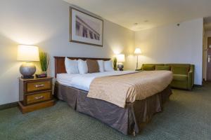 a hotel room with a large bed and a couch at Capital Plaza Hotel in Frankfort +36 photos