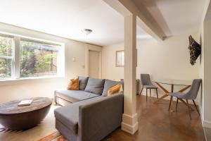 a living room with a couch and a table at Stay Portland - Joshua Tree Vibes in SE PDX - Local Bars & Food in Portland