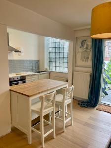 a kitchen with a large wooden table and chairs at The Doors City Park House in Ghent