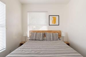 a bedroom with a bed with a striped blanket at Stay Portland - Renovated 3BR Tilikum View in heart of SE Division in Portland