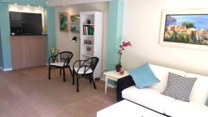 a living room with a couch and a table and chairs at Hotel Creta Paguera in Paguera