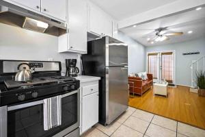 a kitchen with a stove and a refrigerator at Elegant Beachside 2 Bed 2 Bath in Long Beach