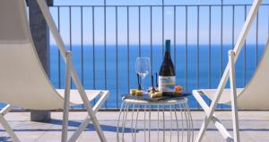 a bottle of wine and a glass on a table at Hotel Due Gemelli in Riomaggiore