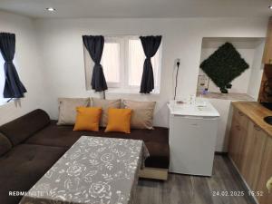 a living room with a couch and a table at Къща за гости Съкровище in Panagyurishte