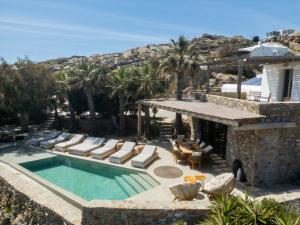 a villa with a swimming pool and a resort at Pure Mykonos Villa in Plintri