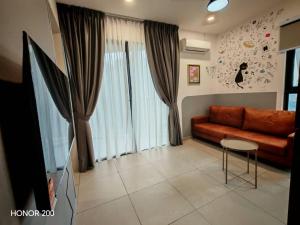 a living room with a couch and a table at Cozy 2BR Getaway for 3 YOLO in Petaling Jaya