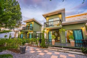 an exterior view of a house with green at Green Garden House กรีนการ์เด้นเฮ้าส์ นครพนม in Nakhon Phanom