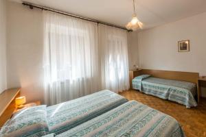 Postel nebo postele na pokoji v ubytování Albergo Antica Rosa + 16 fotografií