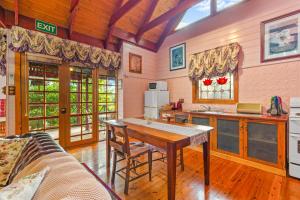 a kitchen with a table and a counter top at StayAU Owls Croft Picturesque Cottage Valley View in Mount Dandenong