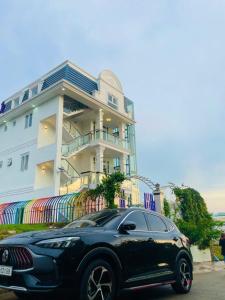 a black car parked in front of a house at Villa Say Nắng Đà Lạt in Da Lat