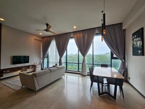 a living room with a couch and a table at Opus Residences by Star Haven in Kuala Lumpur