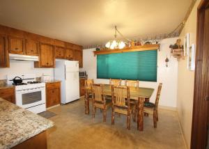 a kitchen with a table and chairs and a refrigerator at HCC0612 - Sitzmark Ski Condo townhouse in South Lake Tahoe