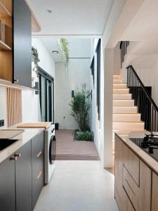 a kitchen with a staircase leading to a house at Naomi Nala Villa Bandung in Gantungan